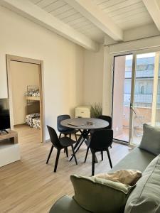 a living room with a table and chairs and a couch at Vera Hotel in Porto San Giorgio