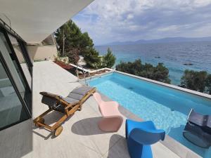a swimming pool with a view of the ocean at Villa Deluxe Zaostrog in Zaostrog