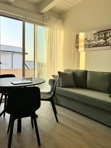 a living room with a couch and a table at Vera Hotel in Porto San Giorgio