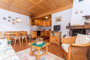 a living room with a couch and a table at Ciase Strim in Falcade +16 photos