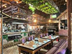 a restaurant with tables and chairs and a bar at Family Hotel Square in Ruse