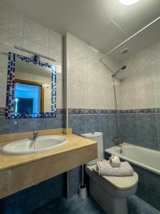 a bathroom with a sink and a toilet and a tub at Surf and Stay House in Corralejo