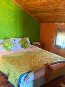 a green bedroom with a bed with green walls at Ανατολή apartment in Néa Meságkala