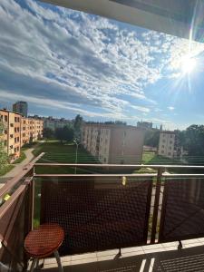 a balcony with a chair and a view of a city at U Lilki in Bolesławiec