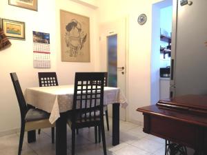 a dining room with a table and chairs and a piano at Apartment Zagor Split in Split