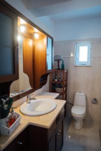 a bathroom with a sink and a toilet at Elegant 3BR Seaside Home with Great View in Mytilini +34 photos