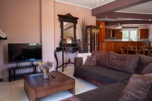 a living room with a couch and a table at Elegant 3BR Seaside Home with Great View in Mytilini