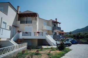 a house with a car parked in front of it at Elegant 3BR Seaside Home with Great View in Mytilini