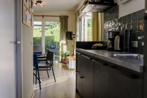 a kitchen with a sink and a counter top at Fijn chalet vlakbij Zeeuwse kust, op familiepark VP047 in Heinkensand