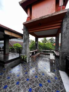 a patio with blue glass shards on the floor at Remedy in Lagas in Ubud