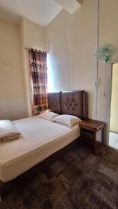 a bedroom with a large bed and a table at Viola in Bukittinggi