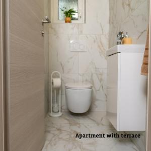a white bathroom with a toilet and a sink at Apartmaji Taler in Bohinj +33 photos