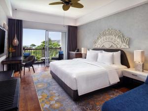 a bedroom with a large white bed and a balcony at Grand Mercure Bali Seminyak in Seminyak +37 photos