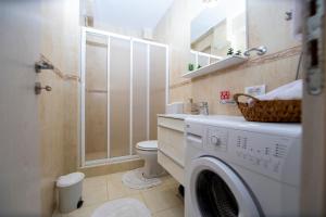 a bathroom with a washing machine and a toilet at Apartments Natasa in Sveti Stefan +10 photos