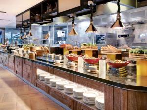 a restaurant kitchen with dishes on a counter at Grand Mercure Bali Seminyak in Seminyak