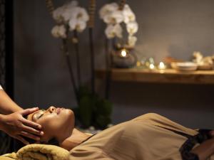 a woman getting a massage from a therapist at Grand Mercure Bali Seminyak in Seminyak