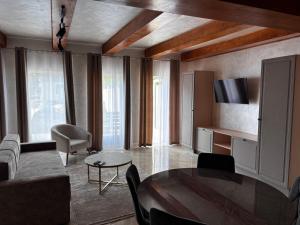 a living room with a table and a television at Complex 88 in Berehove