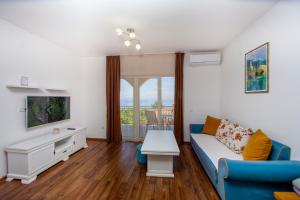 a living room with a couch and a table at Apartments Natasa in Sveti Stefan