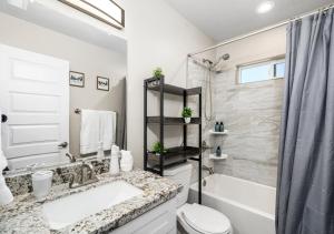 a bathroom with a sink and a toilet and a shower at Travelers Paradise, 3BR House Near Route 66 and Grand Canyon in Williams +33 photos