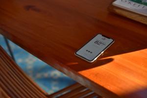 a cell phone sitting on top of a wooden table at Las Casas Chiapas in San Cristóbal de Las Casas