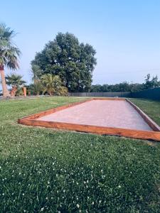 a basketball court in the middle of the grass at Luxury home private duras in Duras