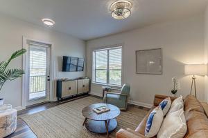 a living room with a couch and a table at Waterfront Condo for 4 with Resort Pool & Lake View in Horseshoe Bay