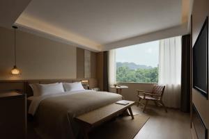 Postel nebo postele na pokoji v ubytování Yanyu Yunxi Resort Hotel 烟雨云兮酒店 + 62 fotografií