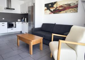 a living room with a couch and a table at Holiday Club Puerto Calma in Puerto Rico de Gran Canaria
