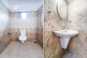 a bathroom with a toilet and a sink at Hotel O City Center Ernakulam in Cochin