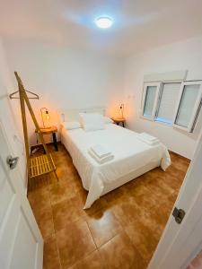 En eller flere senge i et værelse på Vivienda Vacacional Oroarse