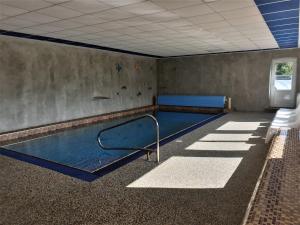 an empty room with a swimming pool in a building at Hotel Park in Ostružná
