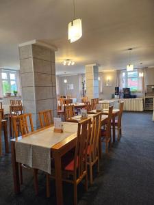 a dining room with wooden tables and chairs at Hotel Park in Ostružná