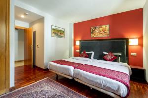 A bed or beds in a room at Hotel Kerala