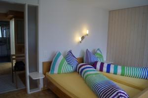 a couch with colorful pillows on it in a room at Fortuna 312 in Leukerbad