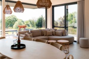 a living room with a couch and a table at La Douce Douve in Heuvelland