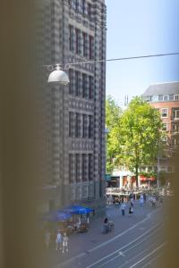 a view of a city street with a tall building at Dream Hotel Amsterdam in Amsterdam