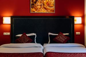 A bed or beds in a room at Hotel Kerala