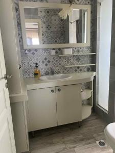 a bathroom with a sink and a mirror at Angels Home in Platanitis +52 photos