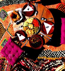 une table en bois avec des bols de nourriture dans l'établissement Gite Tizi Mizik, à Imlil