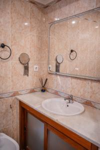 a bathroom with a sink and a mirror at House Pachamama in Olhão