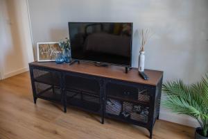 a television on a stand in a living room at House Pachamama in Olhão