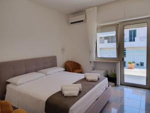 a bedroom with a bed with two pillows on it at La Tartana in Castro di Lecce