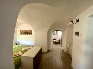 a bedroom with a bed and a table in a room at Il Viaggiatore House in Calice Ligure