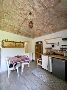 a kitchen with a table and a counter top at Il Viaggiatore House in Calice Ligure