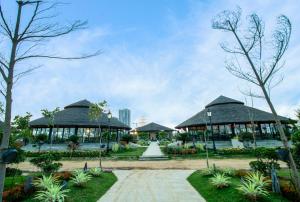 a park with two pavilions and a building at Central Park 2BR Apt Near Gurugram Wid pool Access in Sohna
