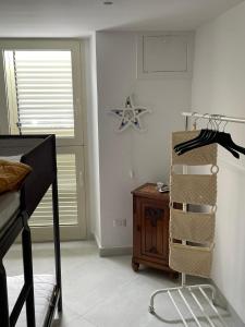 a bedroom with a bed and a dresser next to a window at Le case di Carlotta & Giorgia in Pozzillo