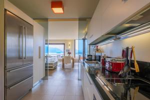 a kitchen with stainless steel appliances and a living room at Casa Bella Vista in Laveno
