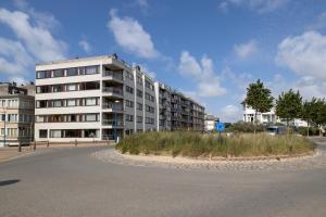 an empty parking lot in front of a building at Spacious family flat near the beach (6-8 pers) in Koksijde