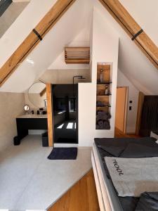an attic bedroom with a bed and a desk at MASTER Suite CasaFux am Graßnitzberg in Grassnitzberg +36 photos