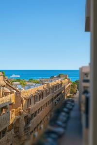 a view of a building with the ocean in the background at Selena Bay Luxury Sea View 1BR Apartment, Private Beach and Pool in Hurghada